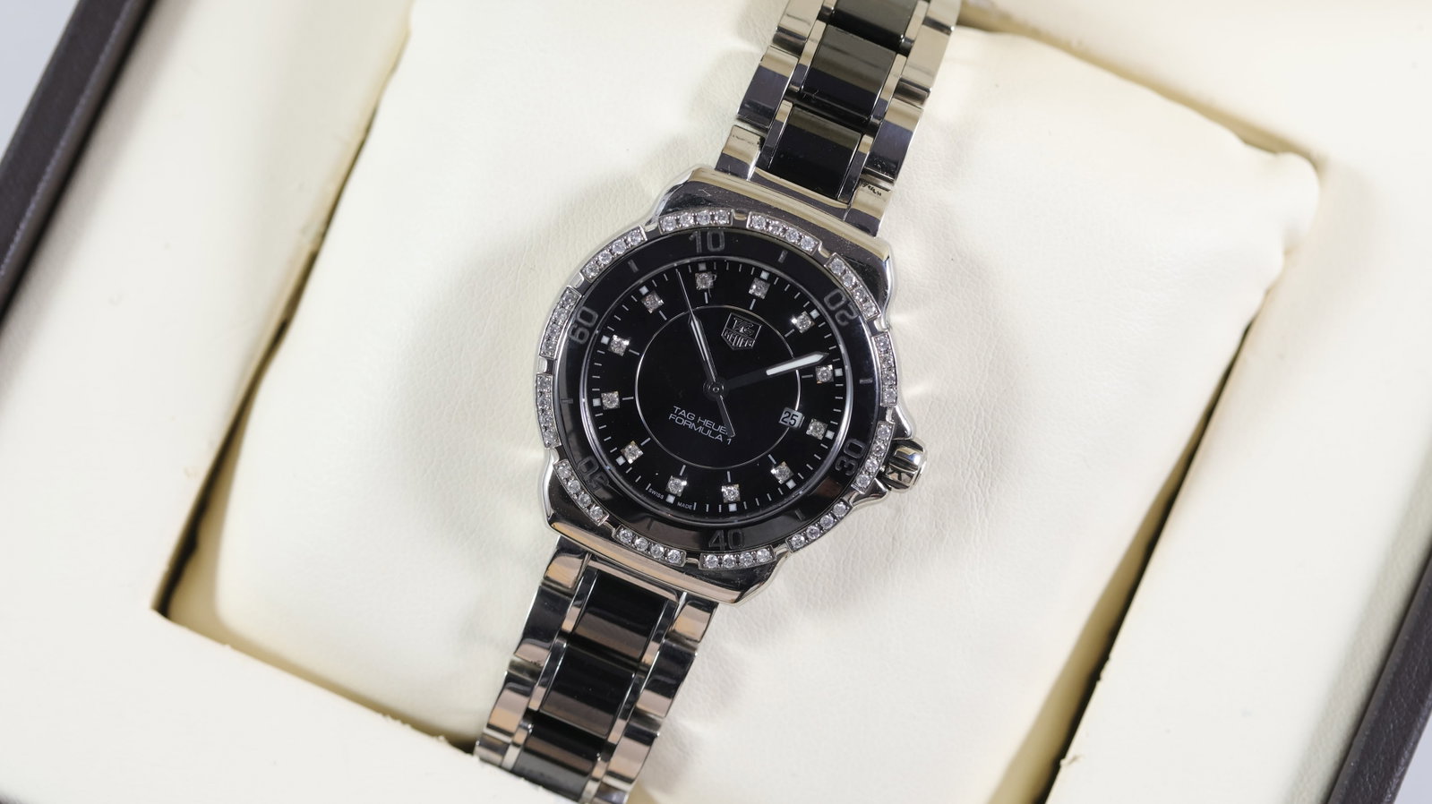 Tag Heuer Formula 1 Ref WAH1312 With Box: Brand: Tag Heuer Model Name: Formula 1 Reference: WAH1312 Movement type: Quartz Dial shape: Circular Dial colour: Black Dial features: Stone set hour markers. Date aperture at 3 o'clock. Bezel: Fixed 