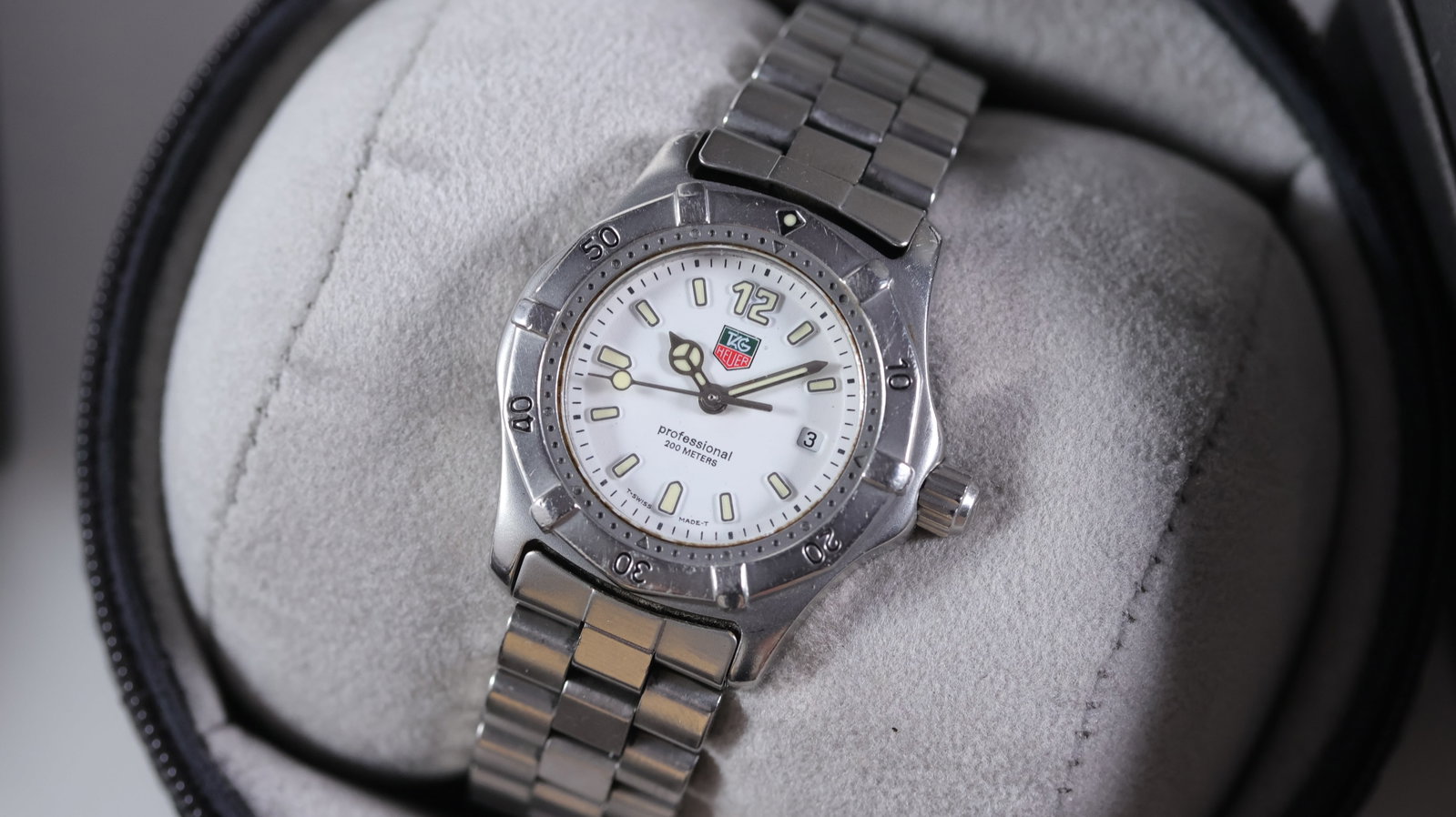 Tag Heuer Professional Ref WK1311 with Box and Papers Circa 1990s: Brand: Tag Heuer Model Name: Professional Reference: WK1311 Movement type: Quartz Year: Circa 1990s Box: Inner and outer box Box features: Tag box Papers: Booklets Dial shape: Circular Dial colour: Wh