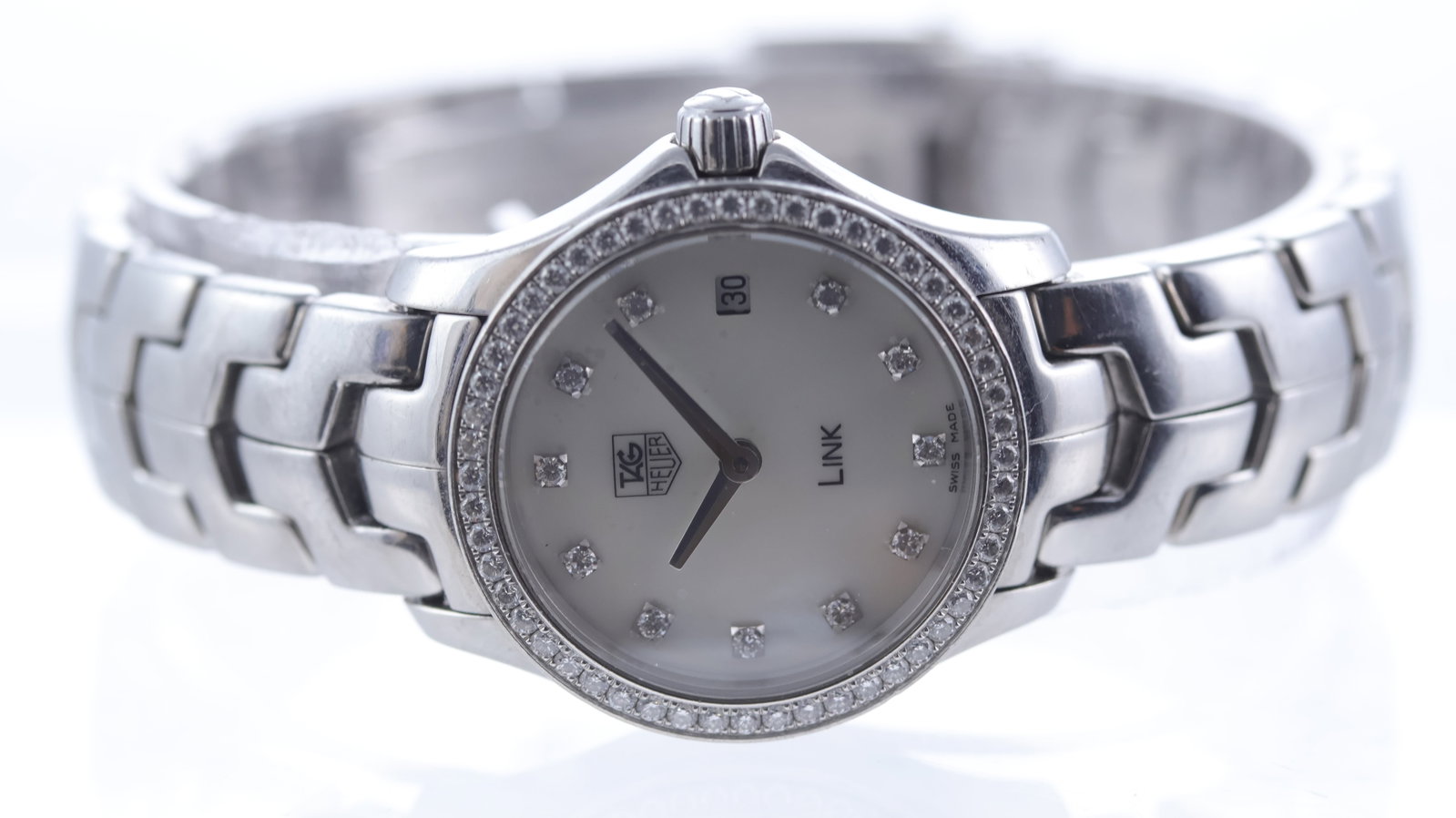 Ladies Tag Heuer Link Quartz Ref WJF1417: Brand: Tag Heuer Model Name: Link Reference: WJF1417 Movement type: Quartz Dial shape: Circular Dial colour: Mother of pearl Dial features: Diamond dot hour markers, quickset date aperture at 3 o'cloc