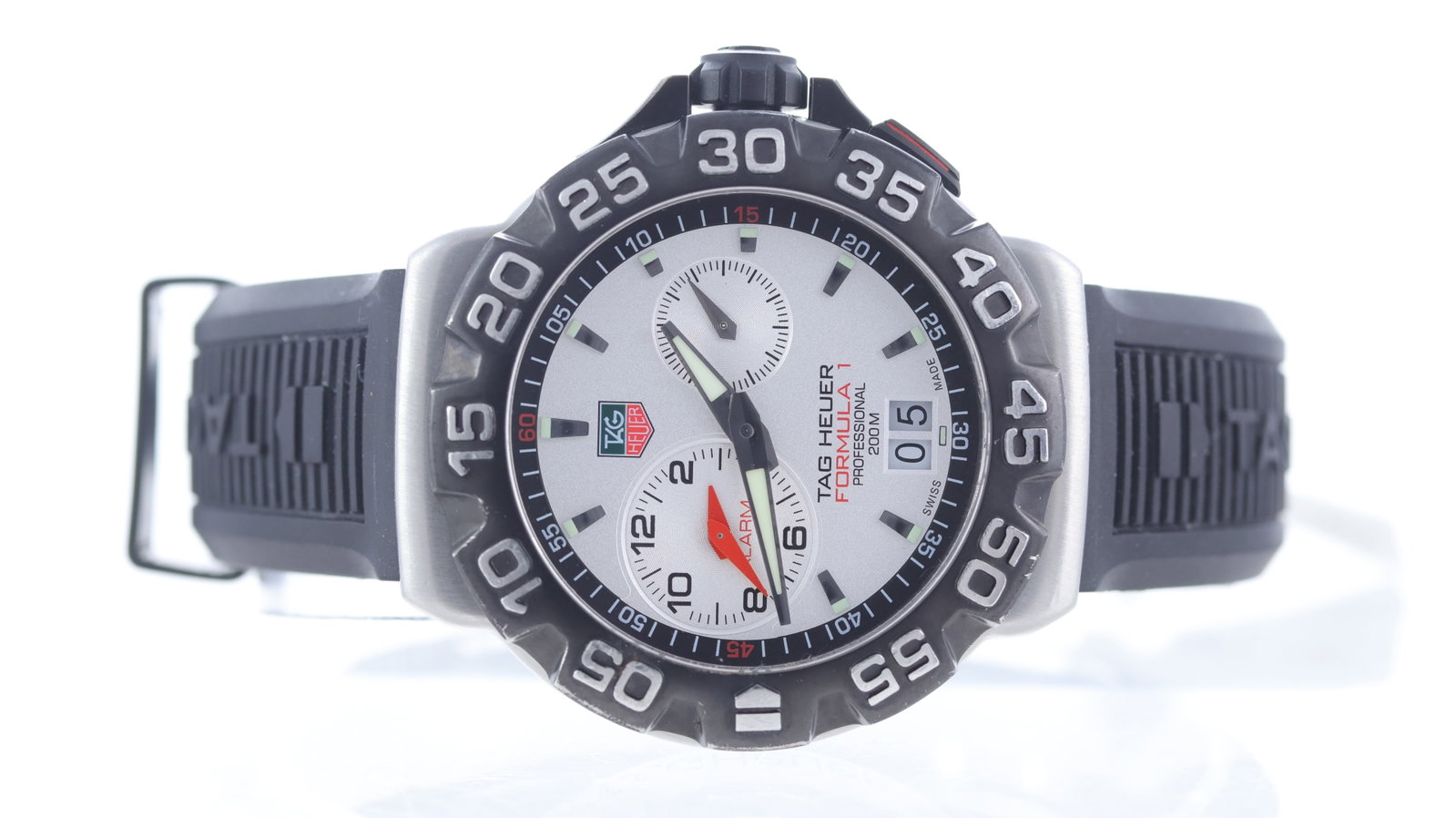 Tag Heuer Formula 1 Alarm Ref WAH111B: Brand: Tag Heuer Model Name: Formula 1 Alarm Reference: WAH111B Movement type: Quartz Dial shape: Circular Dial colour: Silver Dial features: two sub dials, alarm and seconds, outer black track, date