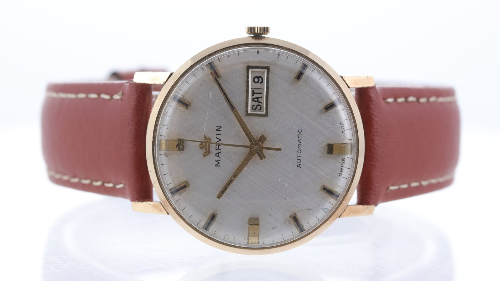Marvin Dress Watch 9ct yellow gold Circa 1970's: Brand: Marvin Model Name: Dress Watch Movement type: Automatic Year: Circa 1970's Dial shape: Circular Dial colour: Silver Dial features: Linen dial with baton hour markers, day and date aperture at