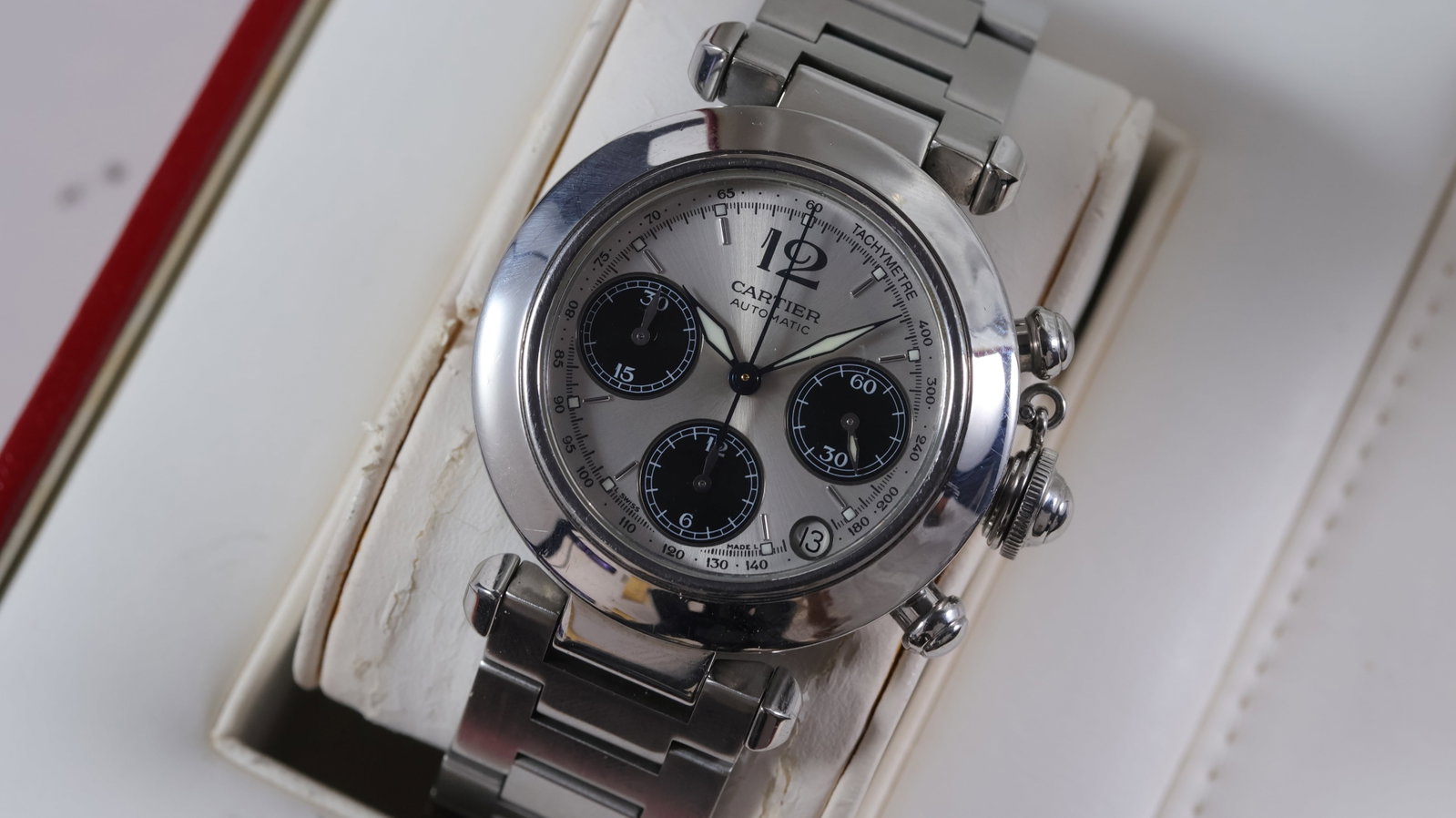 Cartier Pasha Chronograph Automatic Ref 2412 with Box: Brand: CartierModel Name: PashaReference: 2412Movement type: AutomaticBox: inner boxDial shape: CircularDial colour: SilverDial features: Baton hour markers, three black subsidiary dials, date apertur