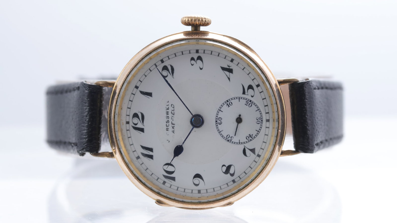 Vintage J. Creswell Wakefield Rolled Gold Trench Watch Circa 1920's: Vintage J. Creswell Wakefield Rolled Gold Trench Watch Circa 1920's, circular white enamel dial with arabic numerals, subsidiary seconds, 33mm rolled gold case, fixed hinge lugs, black leather strap, 
