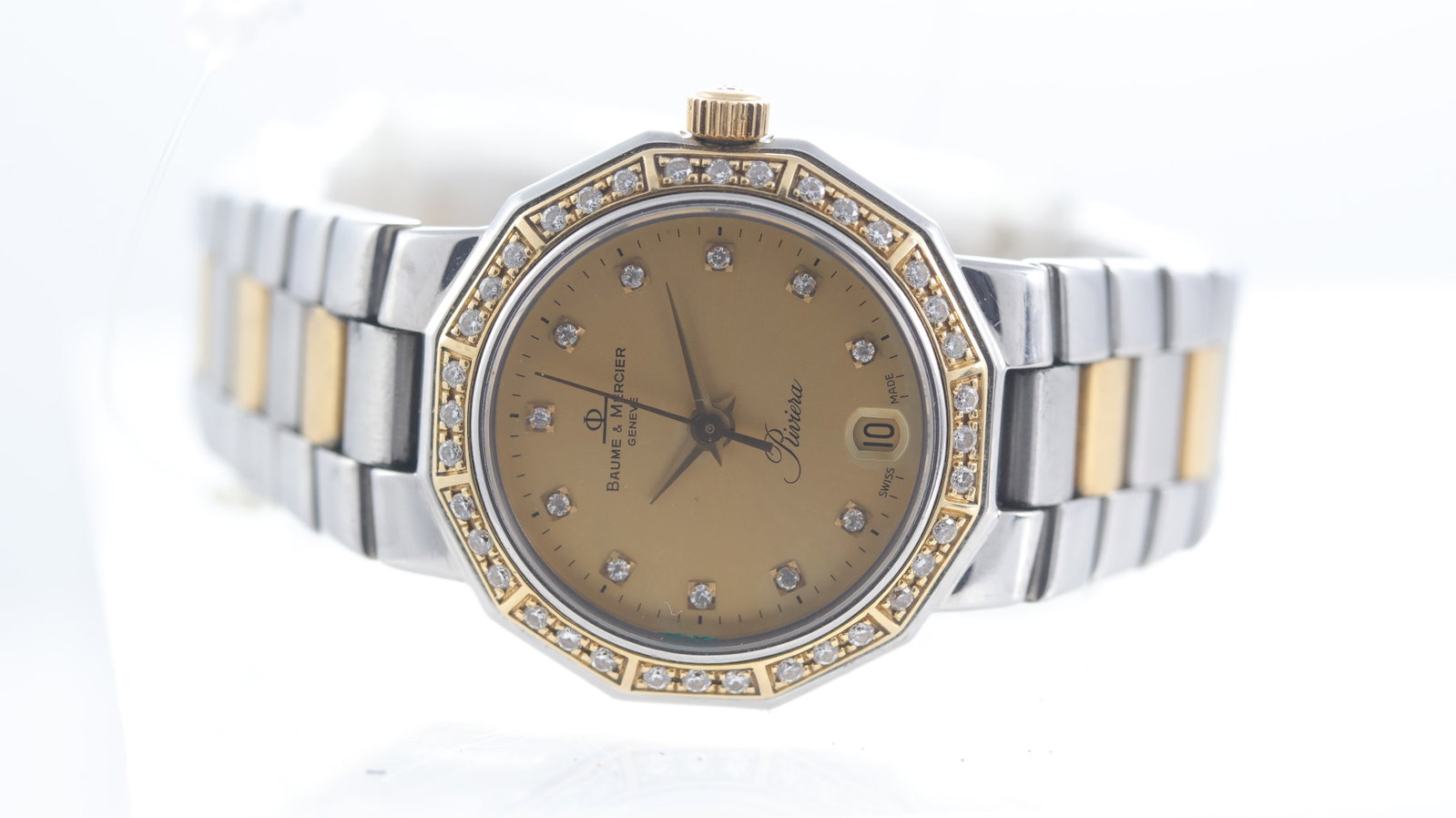 Baume & Mercier Riviera Steel & Gold Diamonds: Brand: Baume & Mercier Model Name: Riviera Movement type: Quartz Dial shape: Circular Dial colour: Champagne Dial features: Diamond dot hour markers, quickset date aperture at 6 o'clock Bezel: