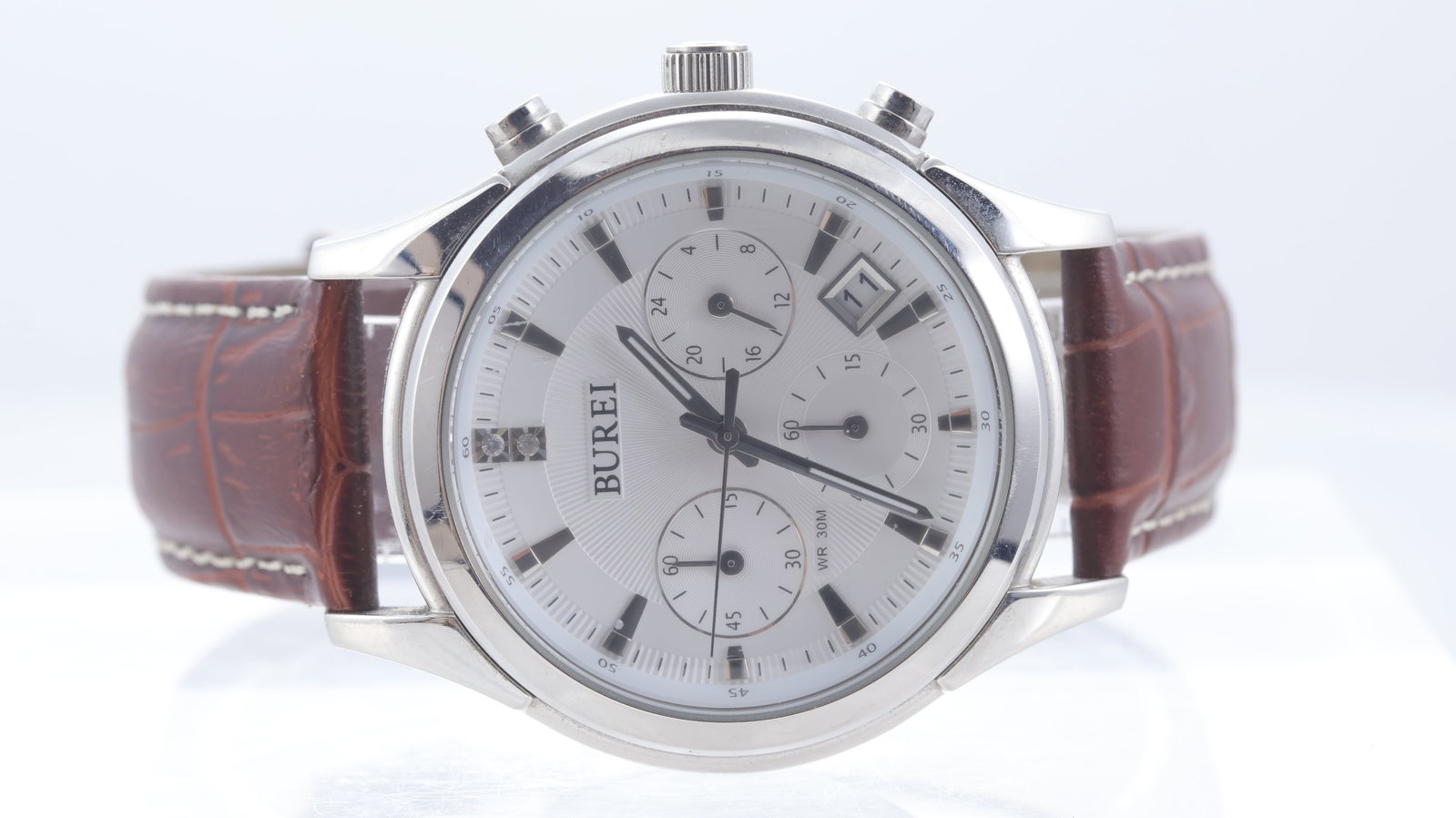 *To Be Sold Without Reserve* Burei Quartz Chronograph Ref 17005M: Brand: Burei Model Name: Chronograph Movement type: Quartz Dial shape: Circular Dial colour: Silver Dial features: Applied hour markers. Sub 24hrs & chronograph. Date aperture at 4:30 o'clock.