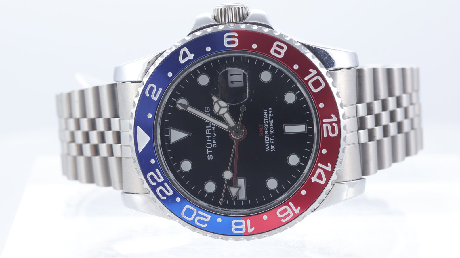 Stuhrling Meridian GMT Quartz Ref 3968 with Box and Associated Papers: Brand: Stuhrling Model Name: Meridian Reference: 3968 Movement type: Quartz Box: Full Box Papers: Associated Papers Dial shape: Circular Dial colour: Black Dial features: Applied hour markers.
