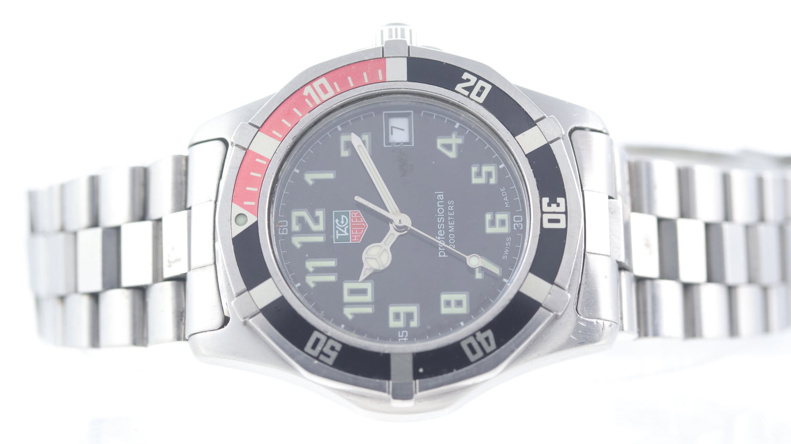 Tag Heuer Professional 'Coke' 2000 Ref WM1112: Brand: Tag HeuerModel Name: Professional 2000Reference: WM1112Movement type: QuartzDial shape: CircularDial colour: BlackDial features: Arabic numeral hour markers. Date aperture at 3 o'clock. Mercede