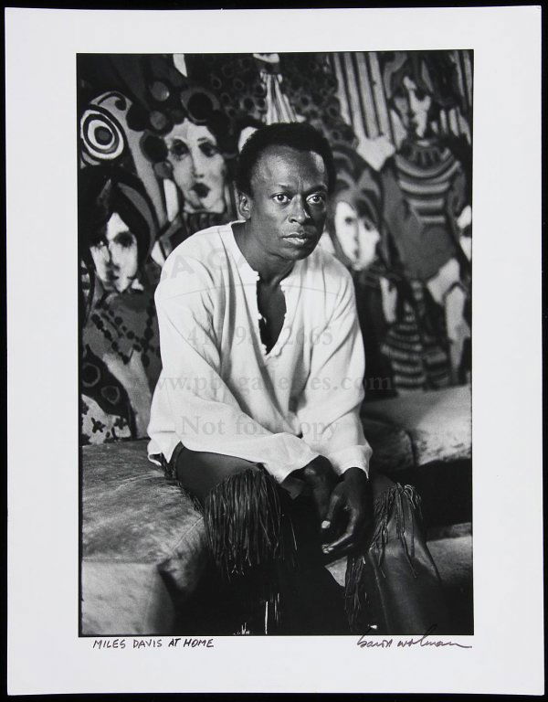 Photo of Miles Davis at Home, Signed by Wolman: Title: Miles Davis at Home - signed photograph Author: Wolman, Baron Description: 11x14, black and white photographic print. Signed by Baron Wolman. Stamped and numbered on verso. Heading: zzhPlace Pu