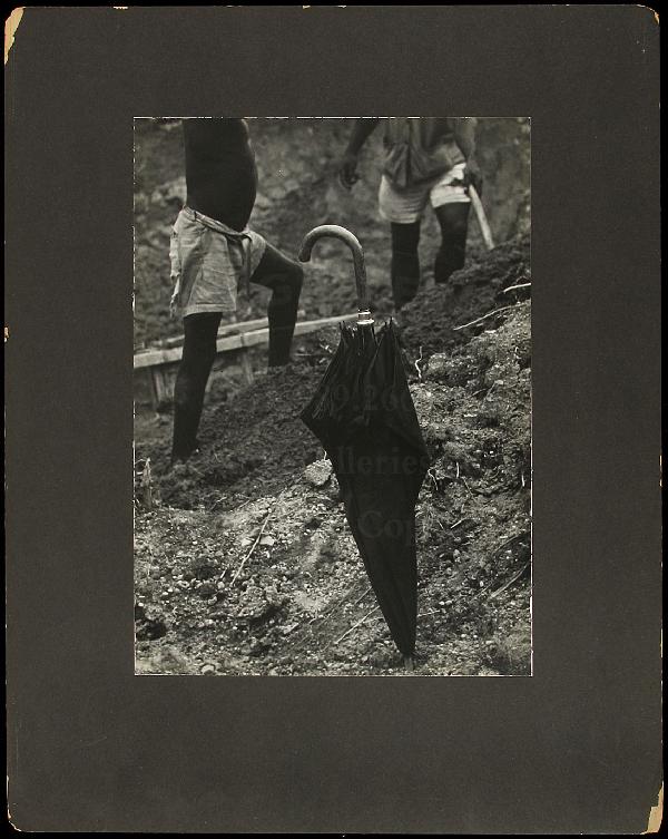 Eugene Smith photo of Leper's Village: Title: Leper's Village, Umbrella in Grond Author: Smith, W. Eugene (1918-1978) Description: Gelatin silver photograph. 13½x9½, mounted on backing board.An umbrella in the ground dominates the image,