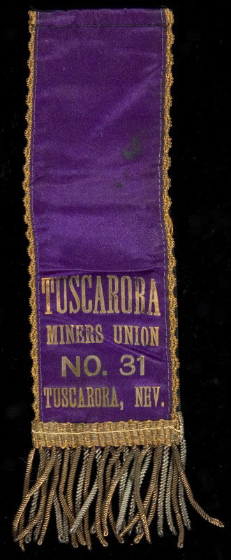 Silk ribbon of the Tuscarora Miners Union 1899: Title: Silk ribbon of the Tuscarora Miners Union No. 31, Tuscarora, Nev. Author: ** Description: Blue silk ribbon with lettering in gold, and gold fringes & tassels. 18x5 cm. (7x2").Tuscarora, now a g