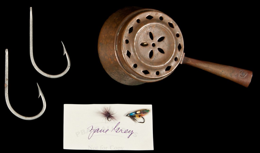 fishing flies, hooks from Zane Grey: Title: Collection of fishing flies, hooks and leaders used by Zane Grey, contained in a small copper pot Author: ** Description: 2 freshwater fishing flies, 2 large metal fishing hooks (3½"), and sev