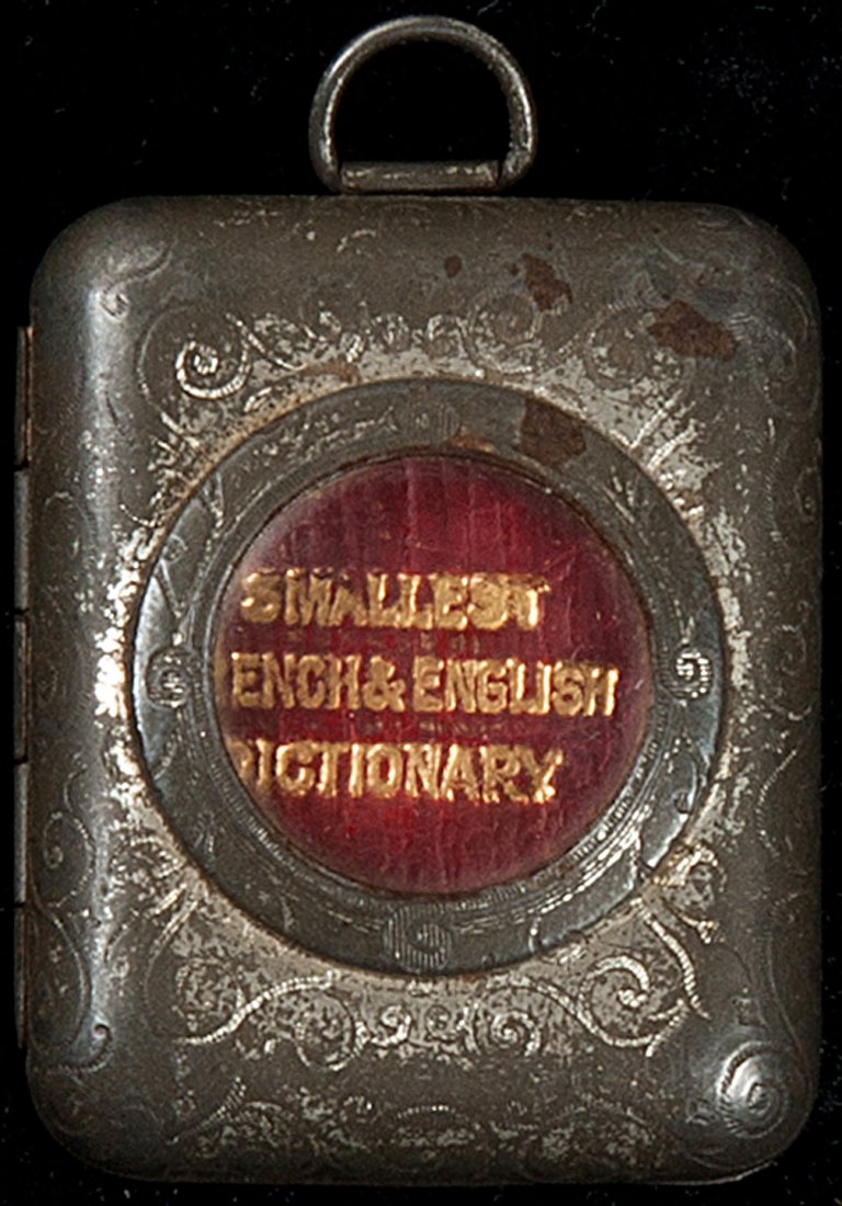 Miniature French-English Dictionary: Title: The Smallest French and English Dictionary in the World Author: ** Description: 617, [1] pp, 27x18mm, thin red morocco, lettered in gilt on upper cover & spine, with original metal locket with 