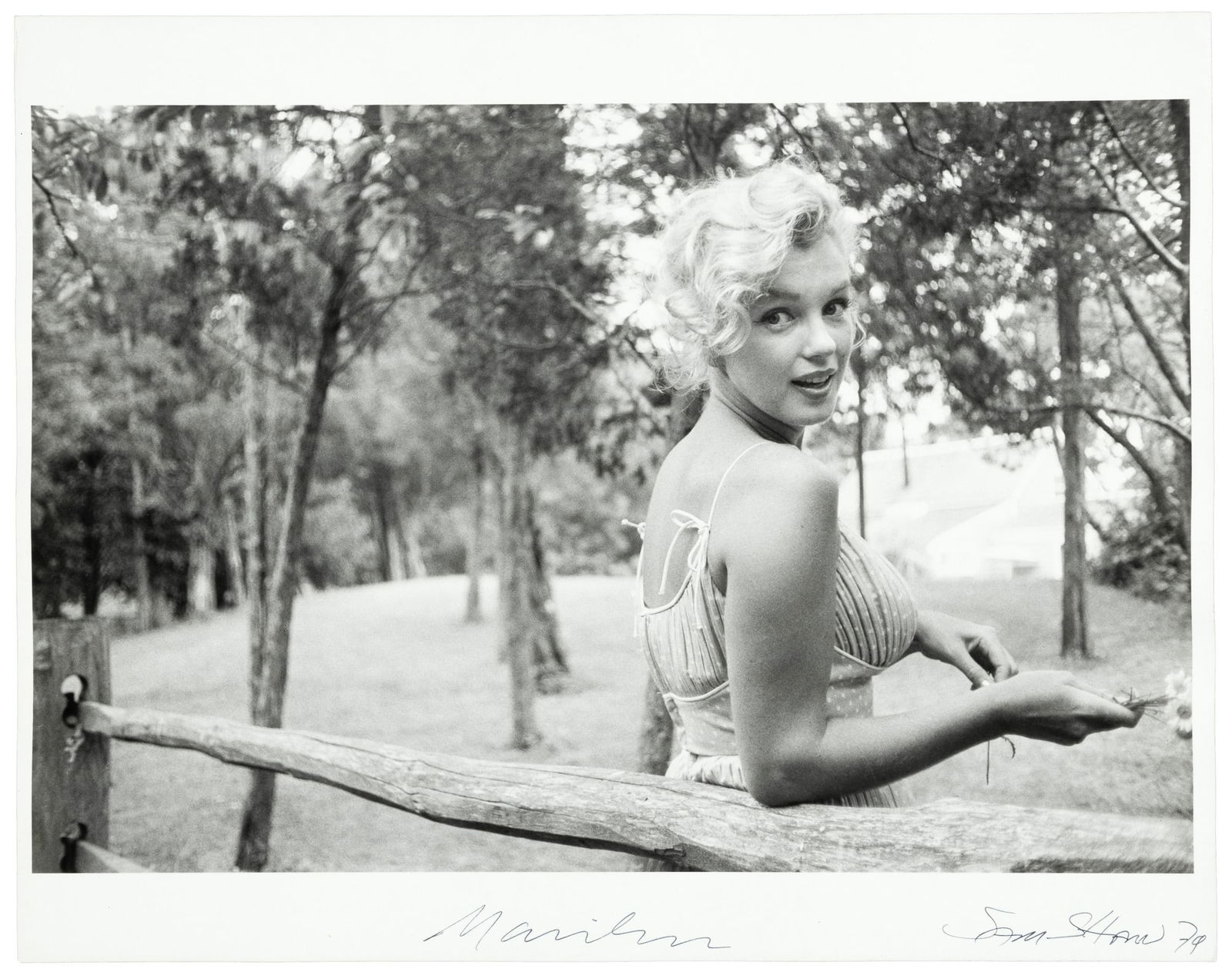Marilyn Monroe with flowers signed by Sam Shaw (1 of 2)