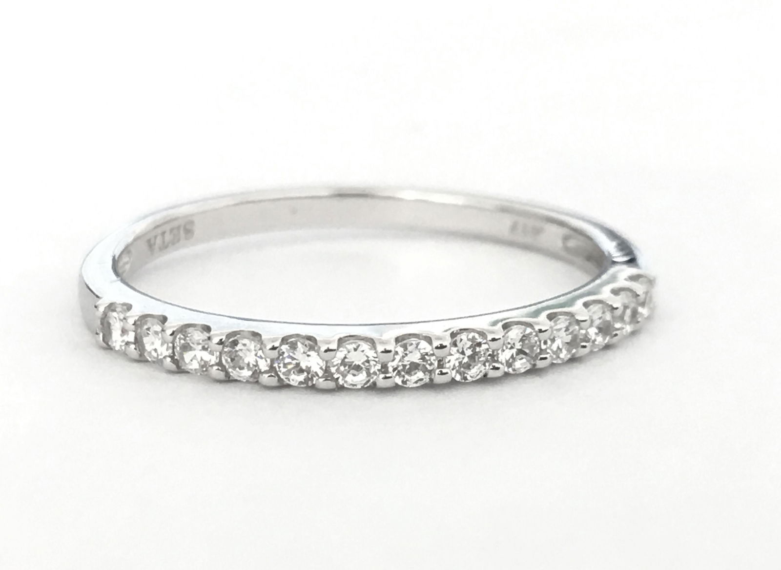 Conflict Free Diamonds & White Gold Engagement Ring: Solid 10k white gold. Total number of diamonds in the ring: 13. Total weight of the ring: 1.70 grams. Round brilliant cut American diamonds set in prongs. Has .417 hallmark on the metal. Beautiful cub