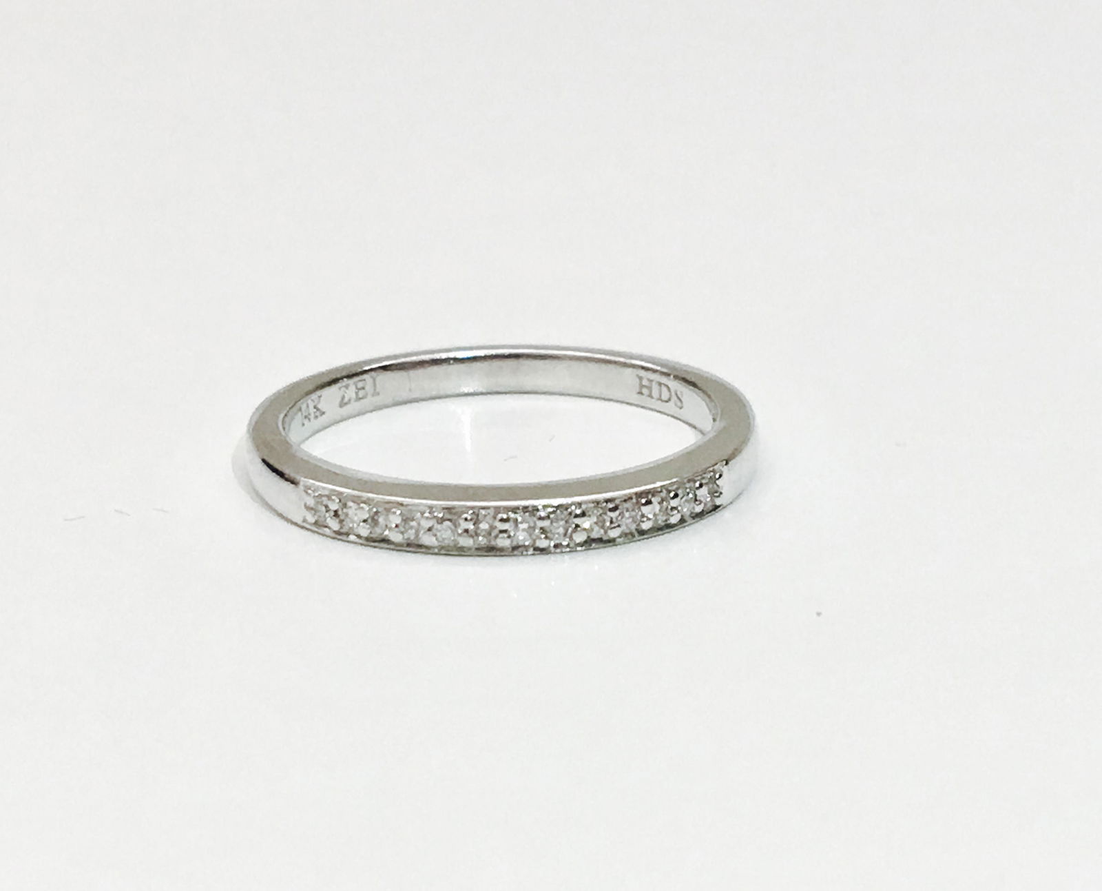 14K white gold and VS/F Diamond wedding band: 14K white gold. VS clarity and F color diamonds. Simple and elegant design. Perfect for weddings and engagement. Has all necessary hallmarks.