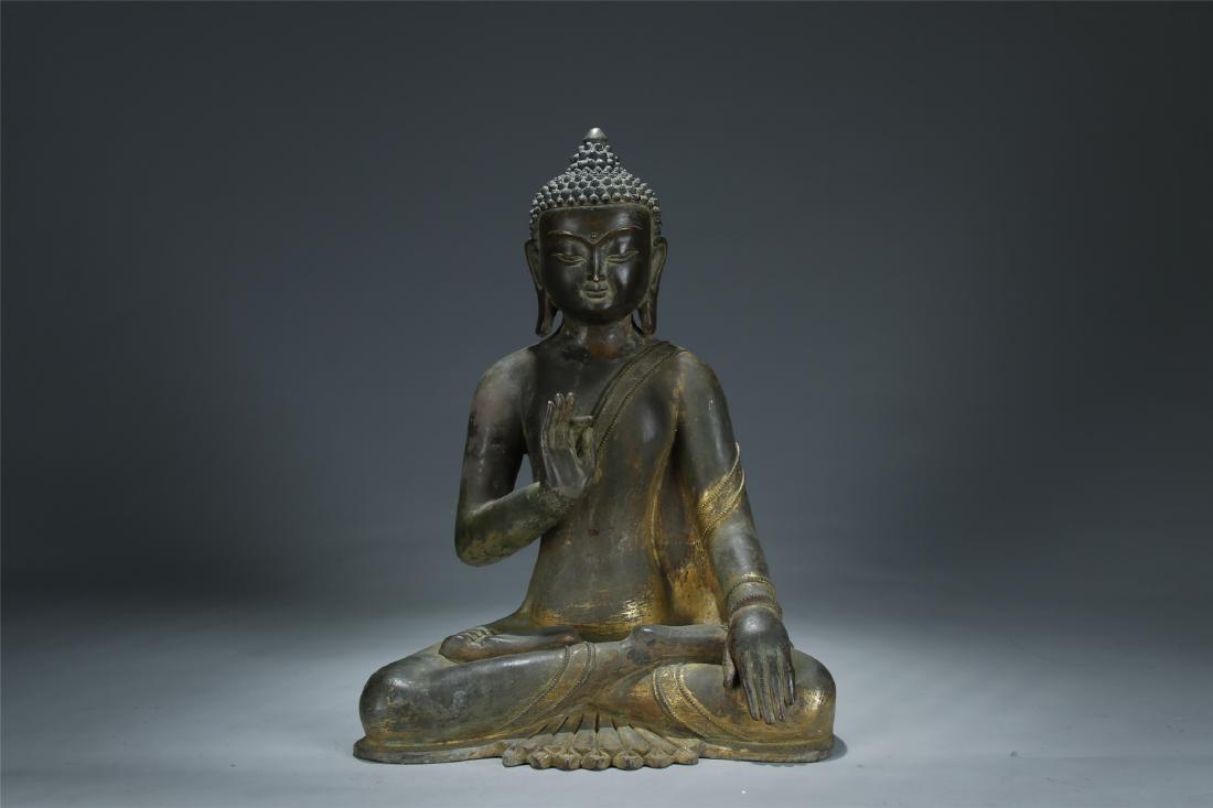 A 19/20th C. gilt bronze figure of Sakyamuni (1 of 9)
