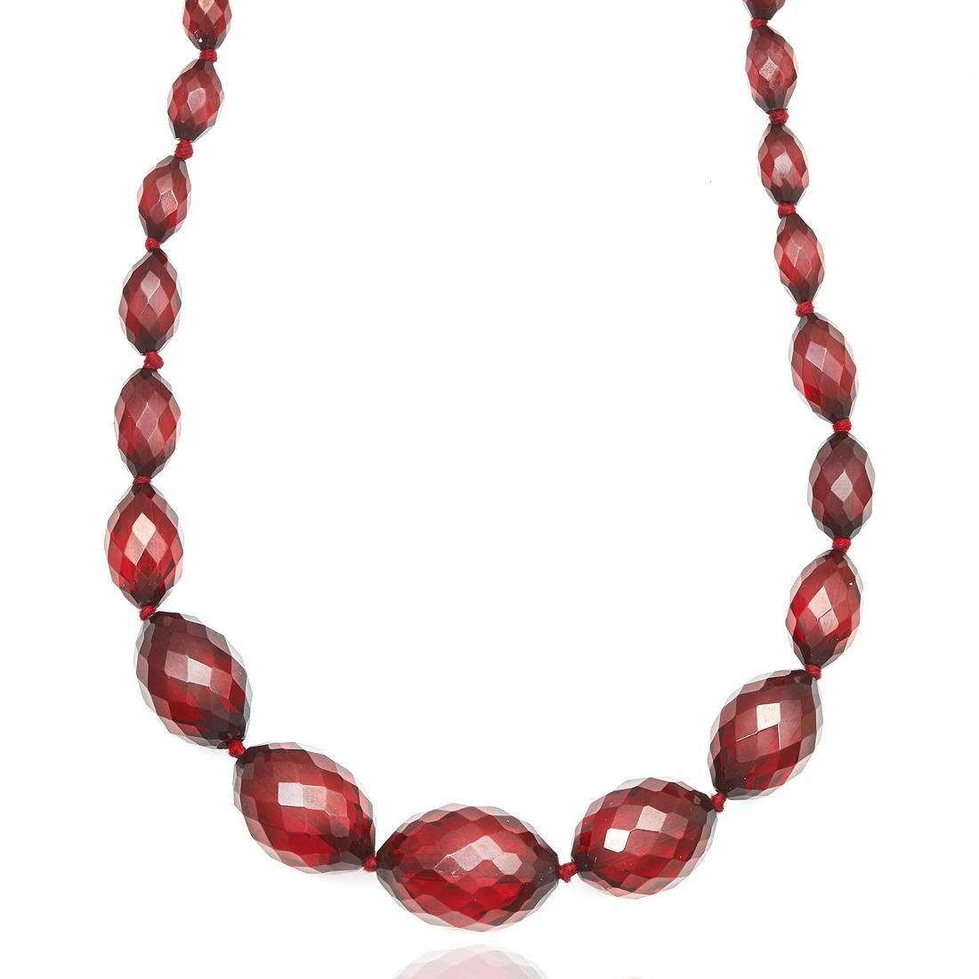 AN ANTIQUE CHERRY AMBER BAKELITE NECKLACE comprising a (1 of 1)