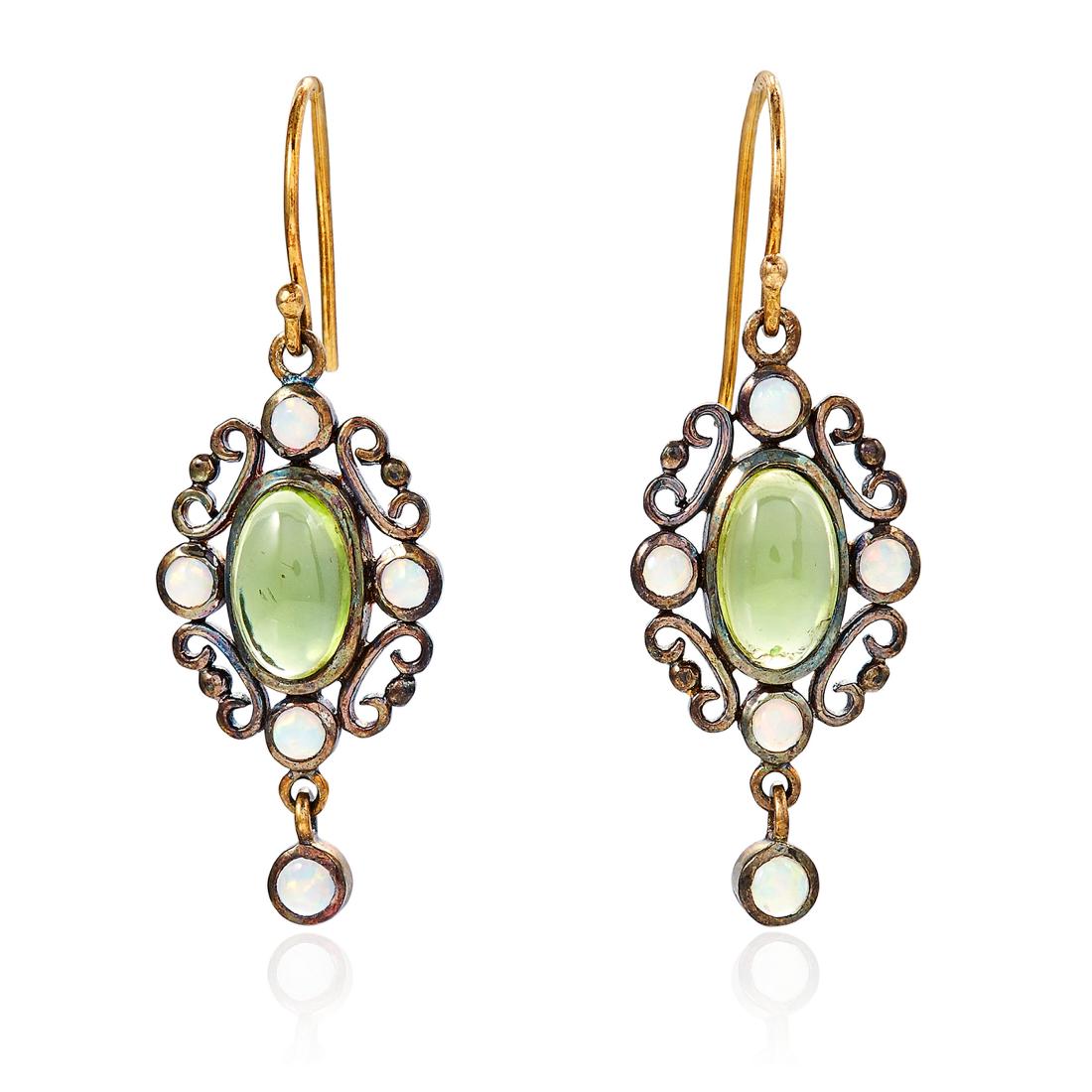 A PAIR OF ANTIQUE PERIDOT AND OPAL EARRINGS in yellow: A PAIR OF ANTIQUE PERIDOT AND OPAL EARRINGS in yellow gold, set with central oval cabochon periods surrounded by scrolling border and four opals, and suspending an opal drop, unmarked, 3.5cm, 4.2g.