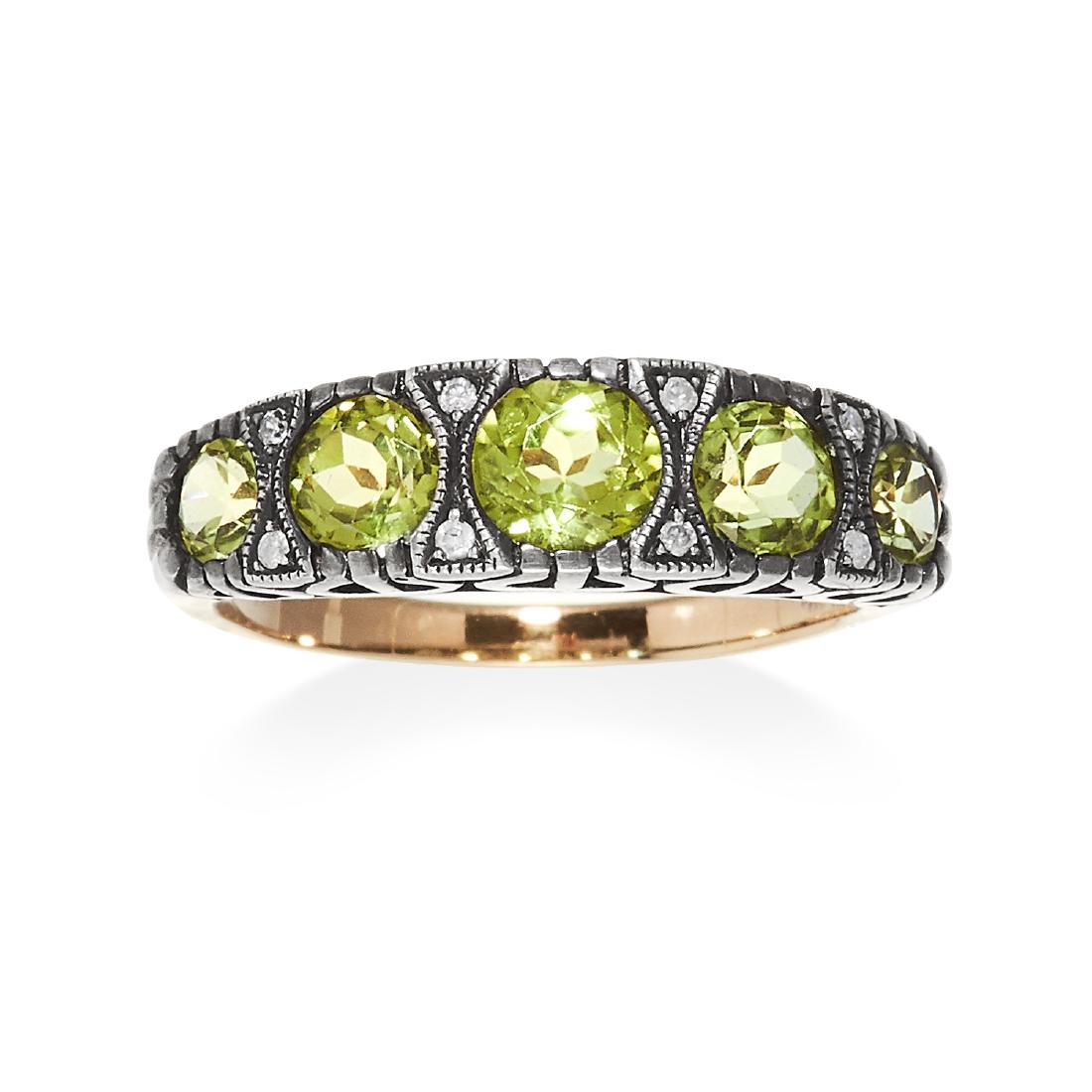 A FIVE STONE PERIDOT RING in yellow gold and silver or (1 of 1)
