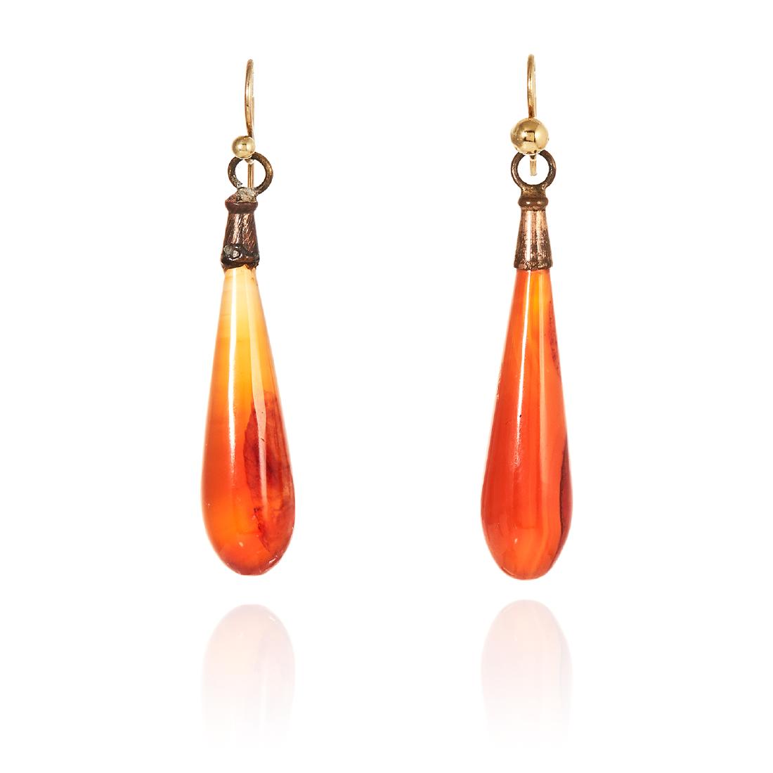 A PAIR OF ANTIQUE CARNELIAN DROP EARRINGS each designed: A PAIR OF ANTIQUE CARNELIAN DROP EARRINGS each designed as a polished tapering carnelian drop, unmarked, 4.3cm, 4.4g.
