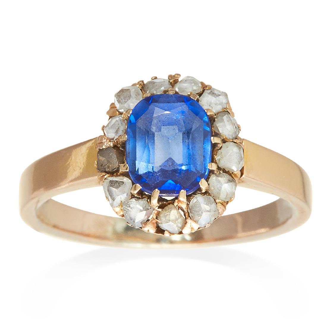 AN ANTIQUE SAPPHIRE AND DIAMOND RING in yellow gold,: AN ANTIQUE SAPPHIRE AND DIAMOND RING in yellow gold, the oval cut sapphire encircled by diamonds, unmarked, size N / 6.75, 3.65g.