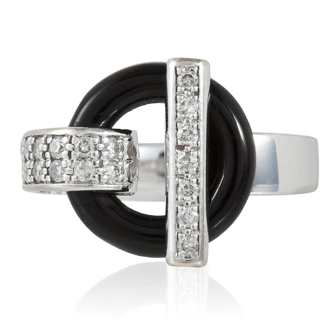 AN ONYX AND DIAMOND RING, GUY LAROCHE in 18ct white: AN ONYX AND DIAMOND RING, GUY LAROCHE in 18ct white gold, the black onyx ring with diamond jewelled t-bar and loop, signed Guy Laroche, French assay marks, size L / 5.75, 5.4g.
