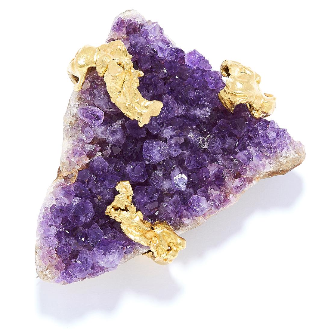 VINTAGE AMETHYST CRYSTAL BROOCH, GRIMA, 1964 in 18ct: VINTAGE AMETHYST CRYSTAL BROOCH, GRIMA, 1964 in 18ct yellow gold, set with a rough triangular amethyst crystal with gold accents, signed HJCo, British hallmarks, 6cm, 58.1g.