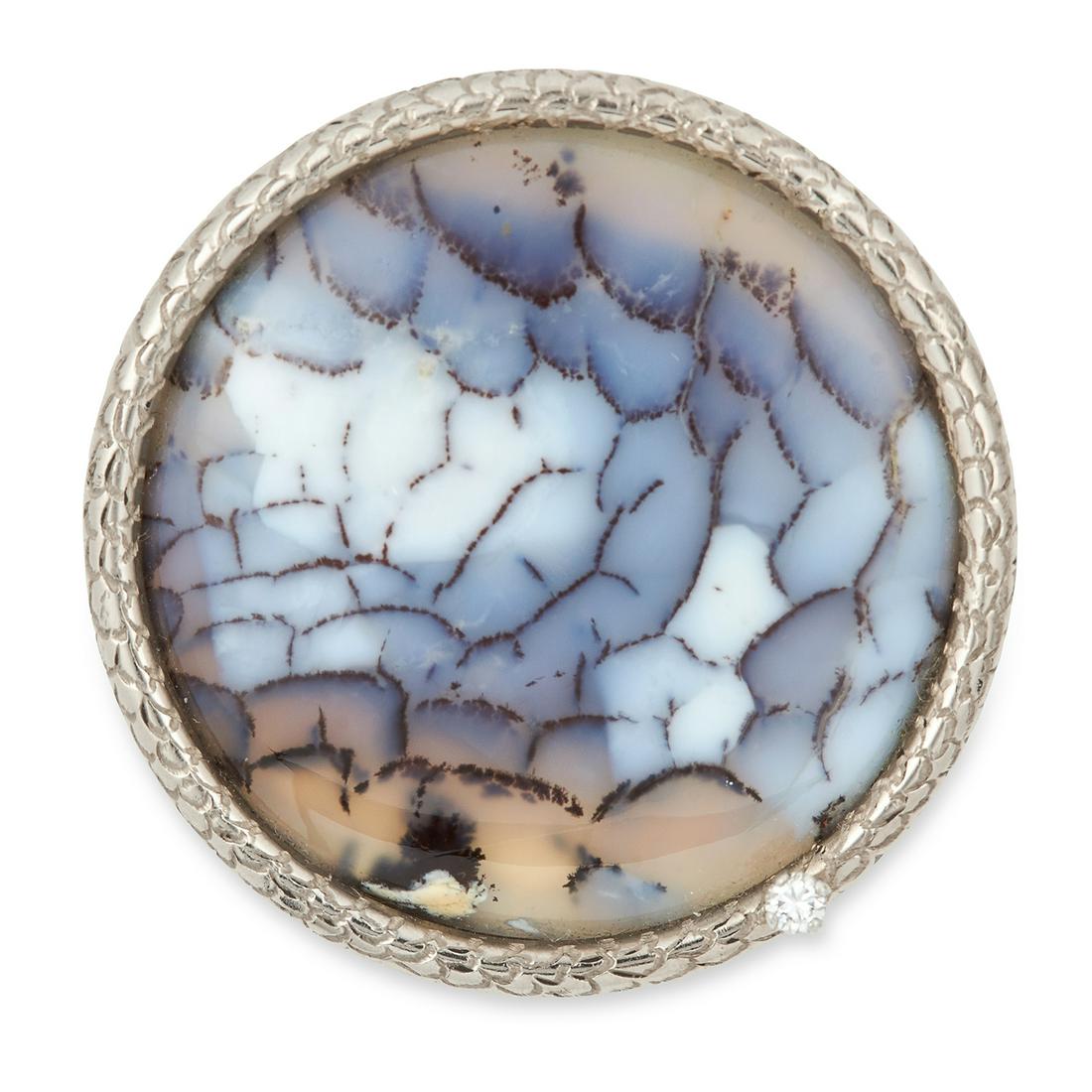 AN AGATE AND DIAMOND BROOCH, ANDREW GRIMA, CIRCA 1970: AN AGATE AND DIAMOND BROOCH, ANDREW GRIMA, CIRCA 1970 set with a polished circular agate panel and a round cut diamond, signed Grima, stamped 750, 3.8cm, 25.4g.