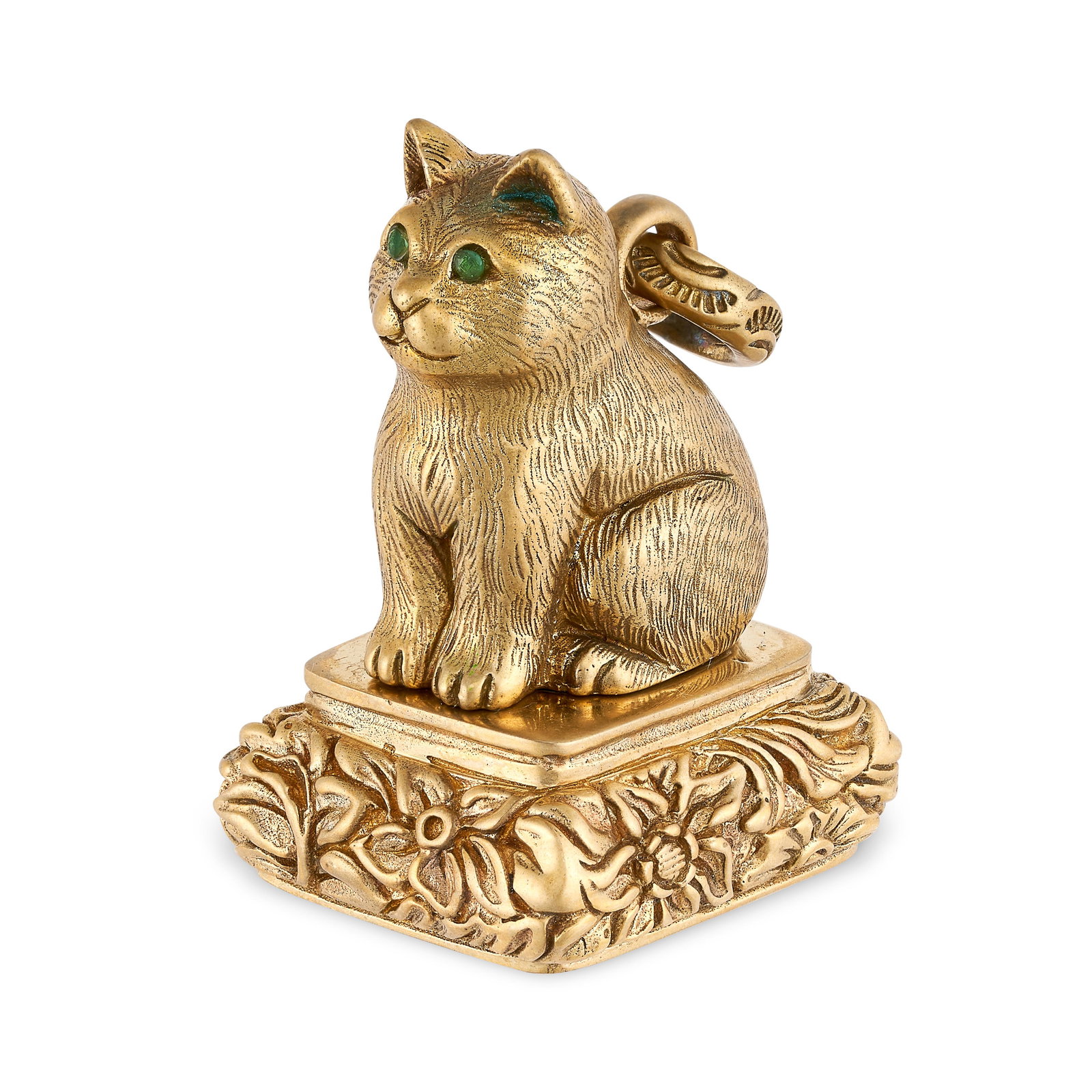A GEMSET CAT FOB SEAL designed as a seated cat atop a: A GEMSET CAT FOB SEAL designed as a seated cat atop a seal with high relief scrolls, the face with a reverse carved coat of arms, with round cut green stones set to the eyes, no assay marks, 4.1cm, 35