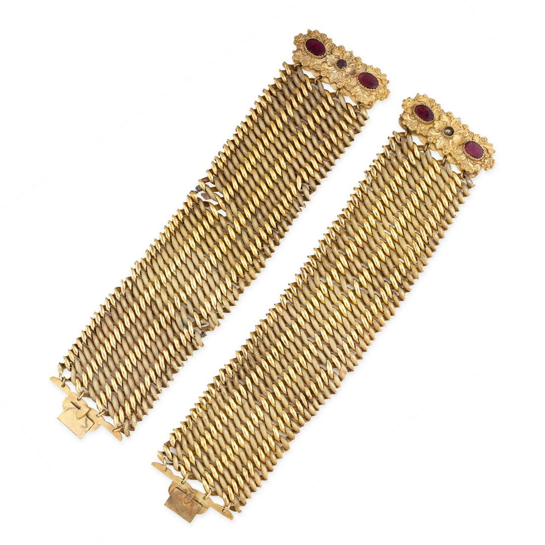 A PAIR OF ANTIQUE GARNET FANCY LINK BRACELETS each: A PAIR OF ANTIQUE GARNET FANCY LINK BRACELETS each formed of a series of articulated textured and polished links, the clasps set with round and oval cut garnets (one deficient), no assay marks, 19.0cm
