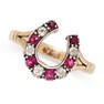 A RUBY AND DIAMOND HORSESHOE RING in yellow gold and silver, set with six round cut rubies and five