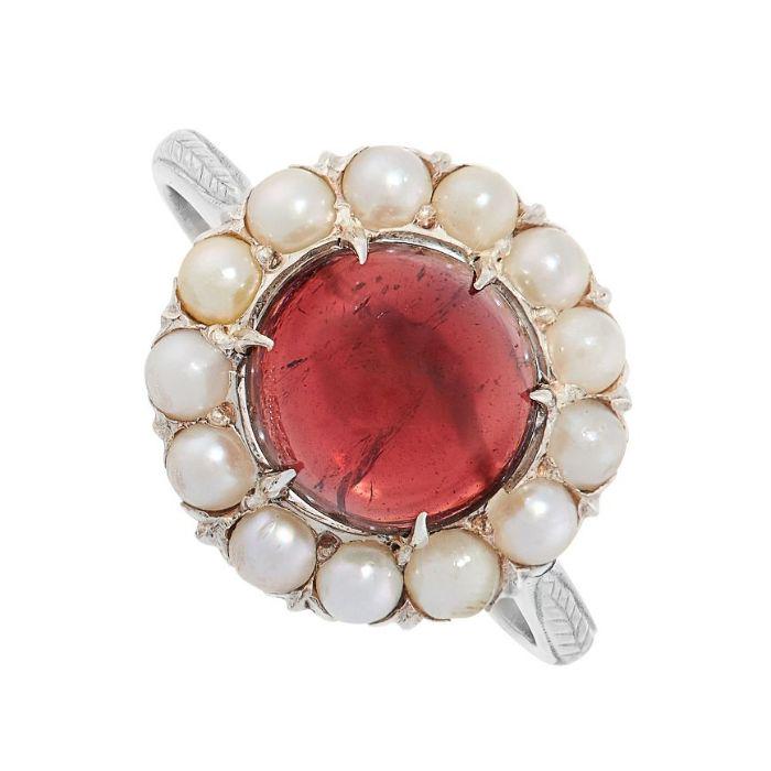 NO RESERVE - A GARNET AND PEARL RING in cluster design, set with a cabochon garnet of 2.98 carats in (1 of 2)