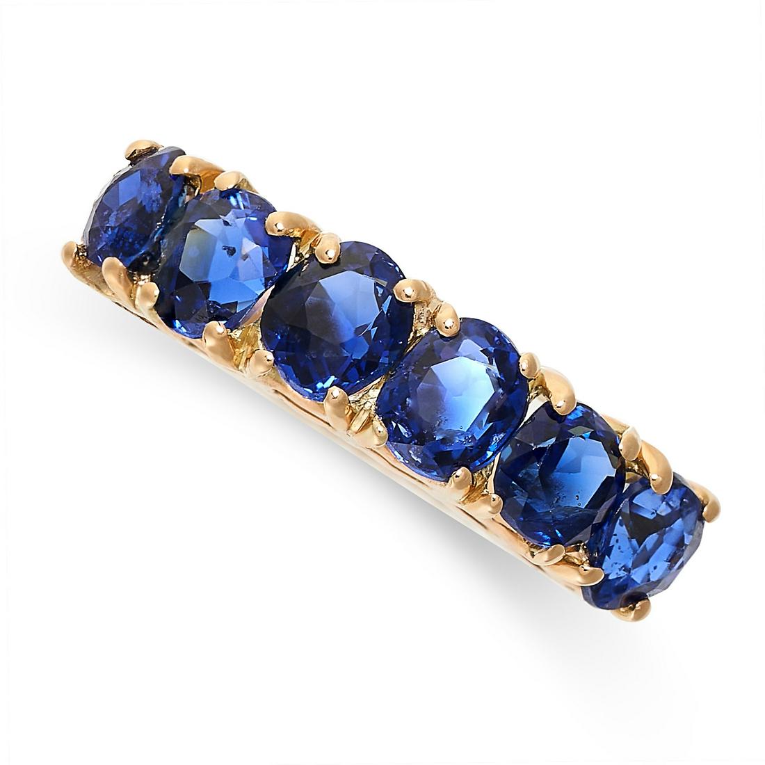 A CEYLON NO HEAT SAPPHIRE DRESS RING in yellow gold, set with a row of six cushion cut blue (1 of 2)