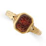 AN ANTIQUE GLASS SEAL SIGNET RING set with a hexagonal piece of orange glass engraved with Arabic