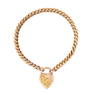 A VINTAGE SWEETHEART BRACELET in 9ct yellow gold, comprising a fancy curb link chain with a heart