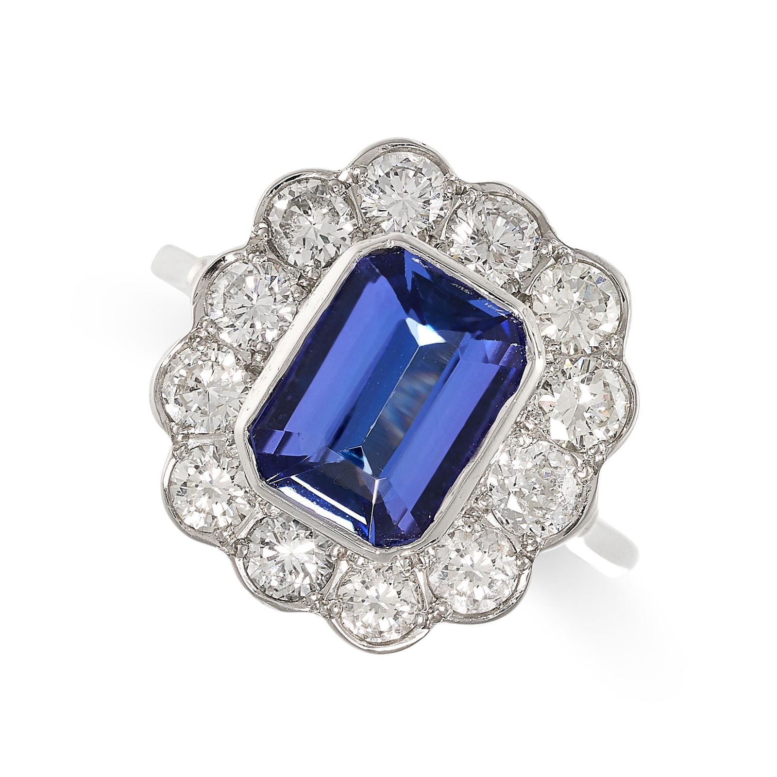 A TANZANITE AND DIAMOND CLUSTER RING in platinum, set with an emerald cut tanzanite of 2.85 carats, (1 of 1)