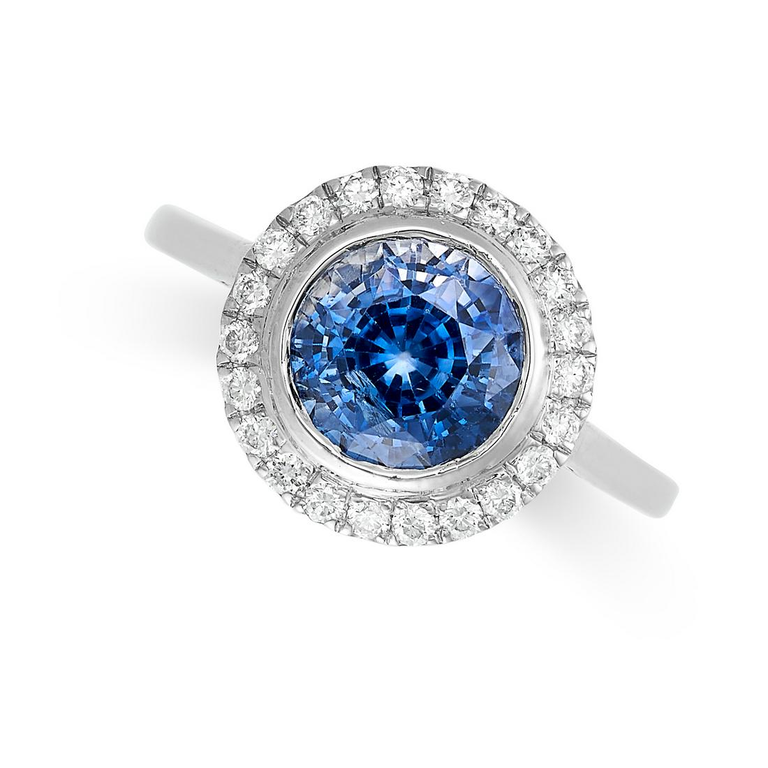 A SAPPHIRE AND DIAMOND CLUSTER RING in platinum, set with a round cut sapphire of 2.66 carats, (1 of 2)