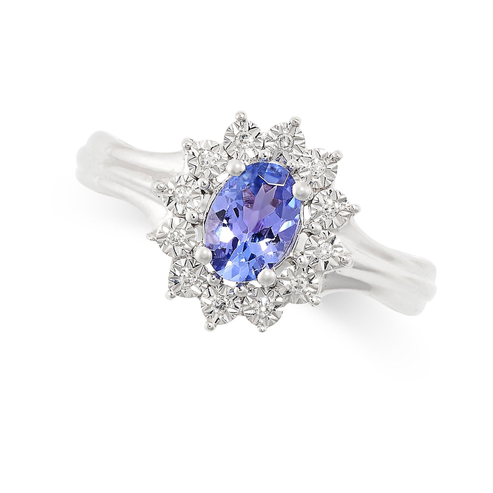 A TANZANITE AND DIAMOND CLUSTER RING set with an oval cut tanzanite in a cluster of illusion set (1 of 1)