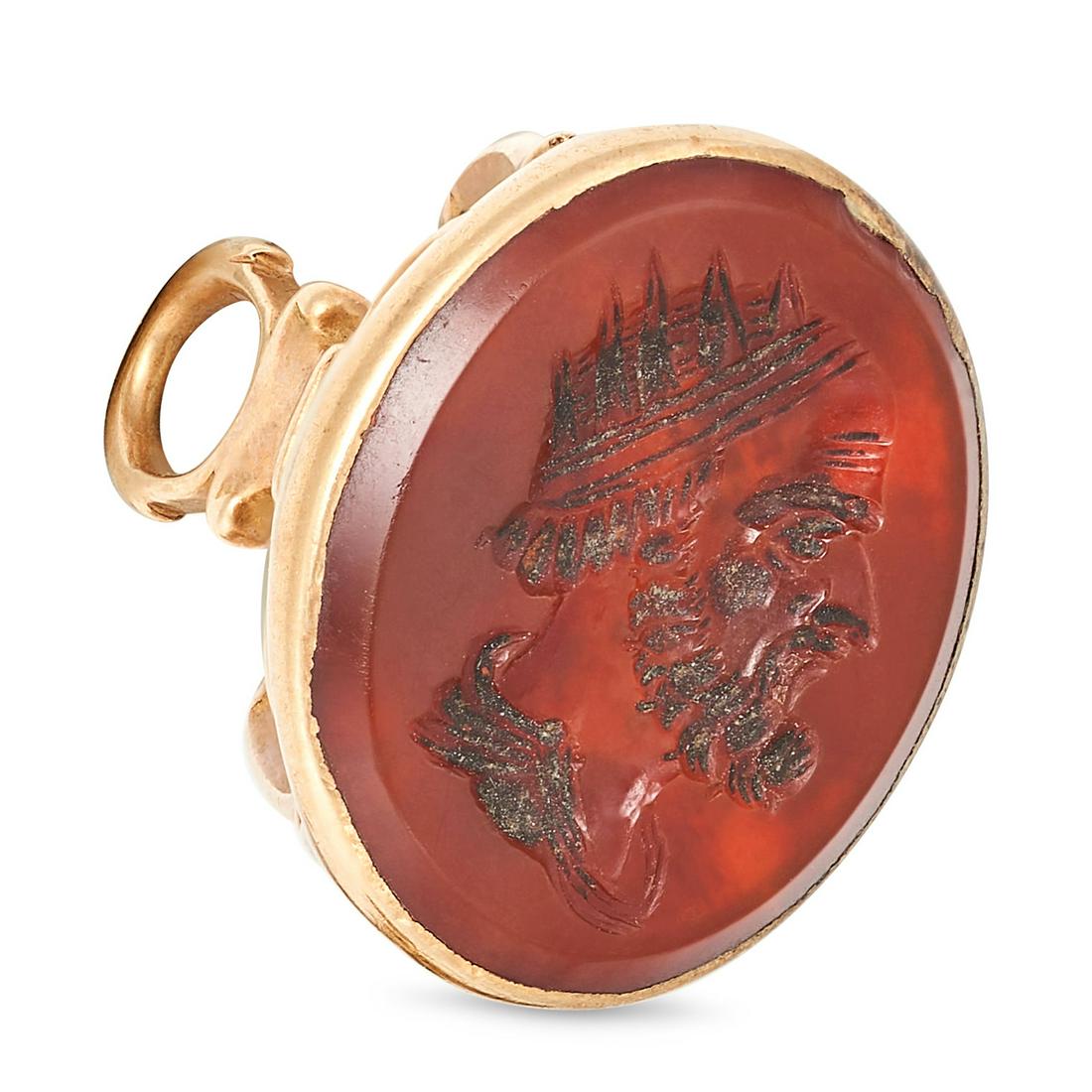 AN ANTIQUE CARNELIAN FOB SEAL in yellow gold, the scrolling body set with an oval carnelian carve...: AN ANTIQUE CARNELIAN FOB SEAL in yellow gold, the scrolling body set with an oval carnelian carved to depict the bust of a classical man, no assay marks, 2.5cm, 4.3g. 