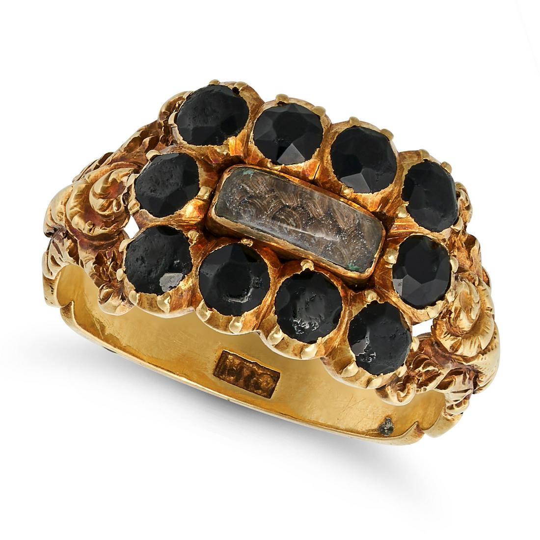 AN ANTIQUE JET MOURNING RING in yellow gold, set with a glass panel containing hairwork in a bord... (1 of 2)
