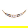 NO RESERVE - AN ANTIQUE MOONSTONE CRESCENT MOON BROOCH in yellow gold, designed as a crescent moon