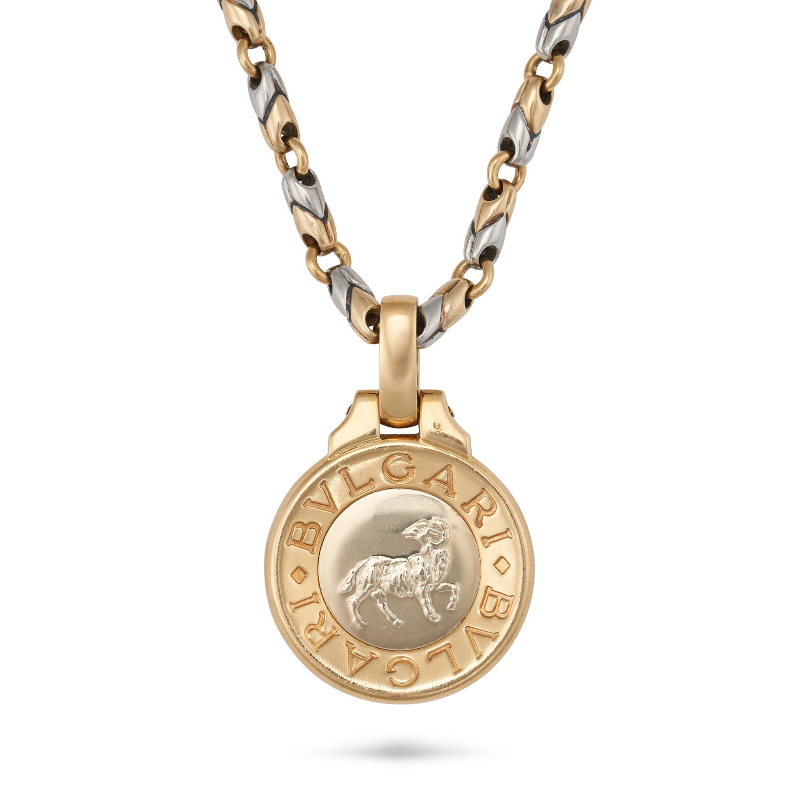 BULGARI, AN ARIES ZODIAC PENDANT NECKLACE in 18ct yellow gold and steel, comprising a fancy chevr...: BULGARI, AN ARIES ZODIAC PENDANT NECKLACE in 18ct yellow gold and steel, comprising a fancy chevron link chain suspending an Aries zodiac pendant, signed Bvlgari, Italian assay marks, pendant 3.5cm, c