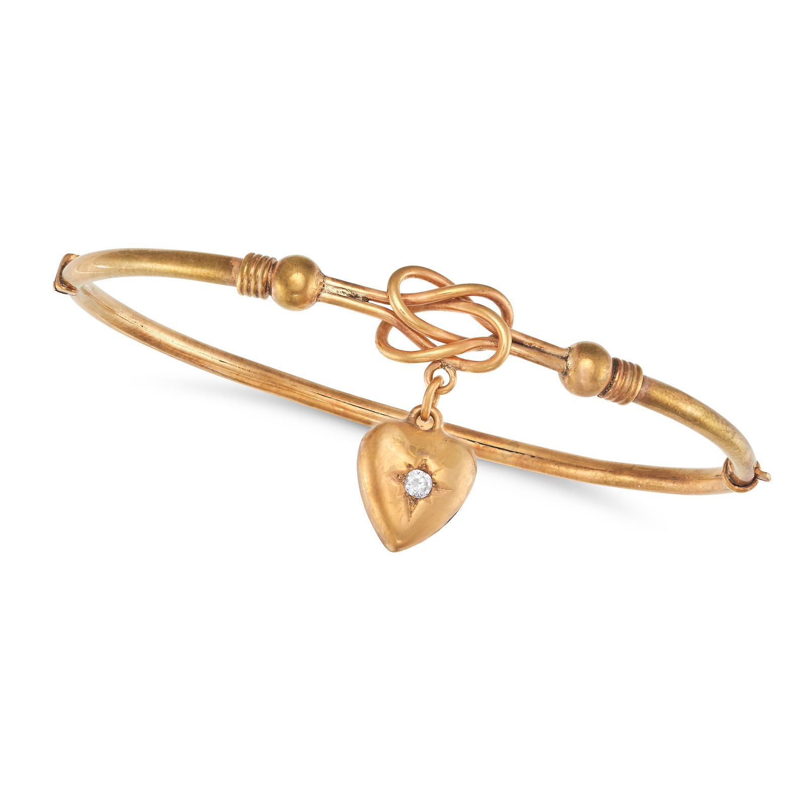 AN ANTIQUE DIAMOND LOVERS KNOT BANGLE in 9ct yellow gold, the hinged bangle comprising a lover's (1 of 1)