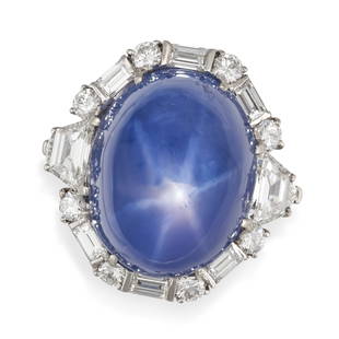 BULGARI, AN IMPORTANT STAR SAPPHIRE AND DIAMOND RING in platinum, set with a cabochon star sapphire: BULGARI, AN IMPORTANT STAR SAPPHIRE AND DIAMOND RING in platinum, set with a cabochon star sapphire of approximately 67.71 carats in a border of round brilliant, baguette and trapezoid diamonds, the