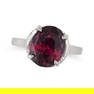 A GARNET RING in platinum, set with an oval cut garnet of approximately 7.80 carats, no assay marks,
