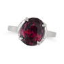 A GARNET RING in platinum, set with an oval cut garnet of approximately 7.80 carats, no assay marks,