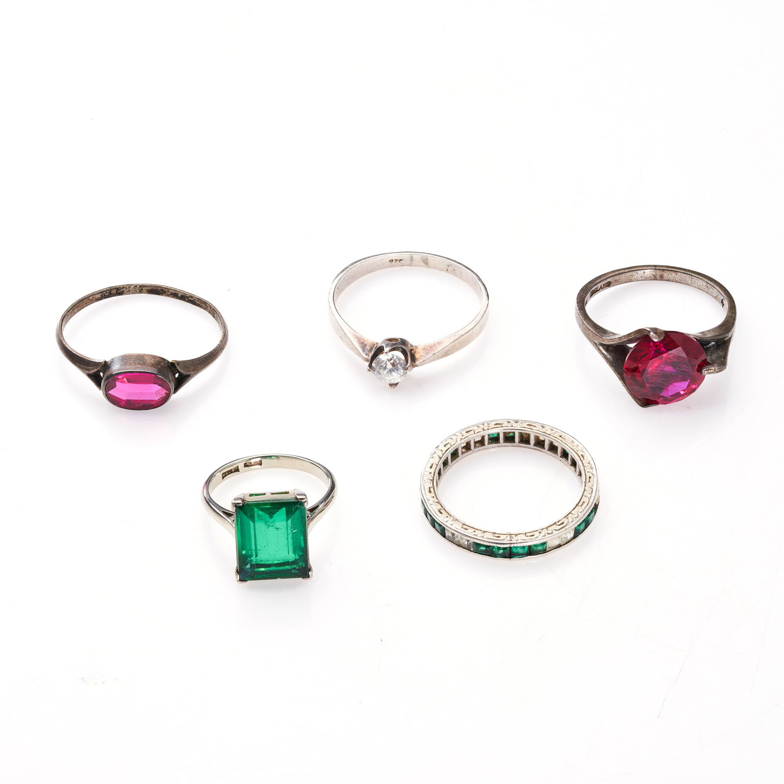 NO RESERVE - A COLLECTION OF FIVE RINGS comprising a white and green paste eternity ring no assay (1 of 1)