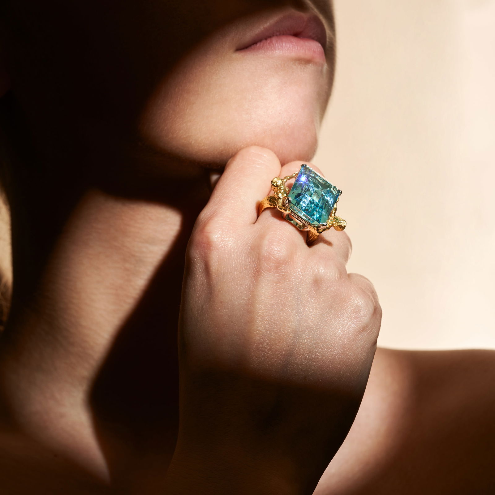 JULIUS COHEN, AN AQUAMARINE AND DIAMOND DRESS RING set with an octagonal step cut aquamarine of a...: JULIUS COHEN, AN AQUAMARINE AND DIAMOND DRESS RING set with an octagonal step cut aquamarine of approximately 27.15 carats accented by round brilliant cut diamonds, the shoulders designed as a merman