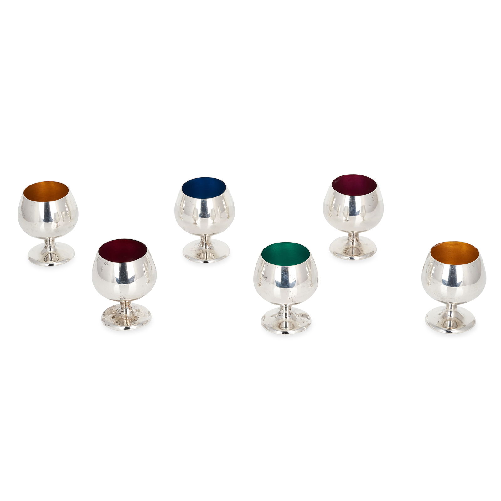 NO RESERVE - A SET OF SIX STERLING SILVER AND ENAMEL LIQUEUR CUPS, GORHAM STERLING, designed as m...: NO RESERVE - A SET OF SIX STERLING SILVER AND ENAMEL LIQUEUR CUPS, GORHAM STERLING, designed as miniature wine goblets, the inside of each enamelled in blue, green, yellow and pinkish red, stamped 'Go