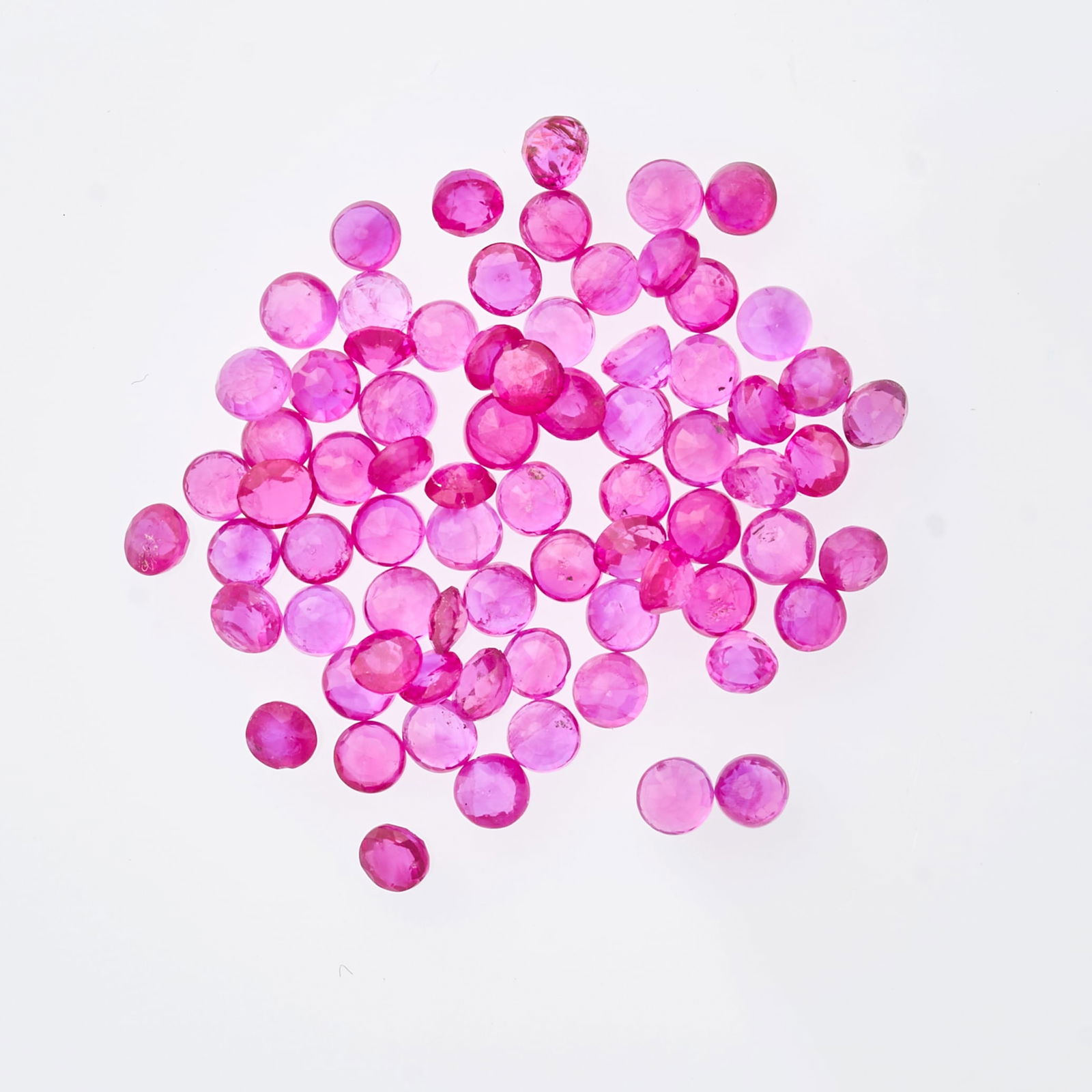 A COLLECTION OF UNMOUNTED RUBIES round cut, all totalling 7.10 carats. (1 of 1)